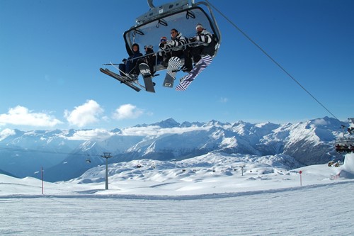 Madonna di Campiglio ski resort-Italy-boarder on chairlift from below