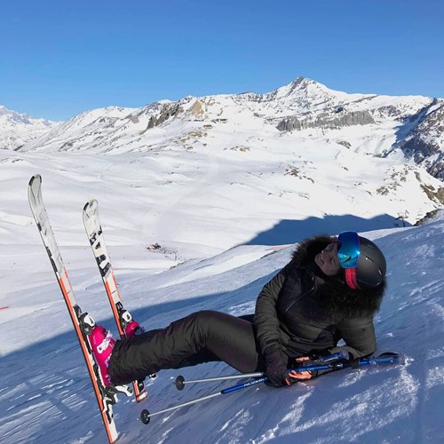 woman lying down on ski slope val d'isere