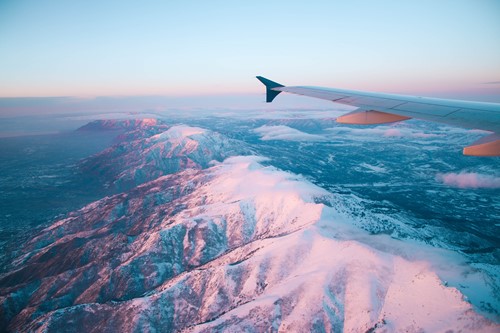 plane flying over mountains ski more sustainably