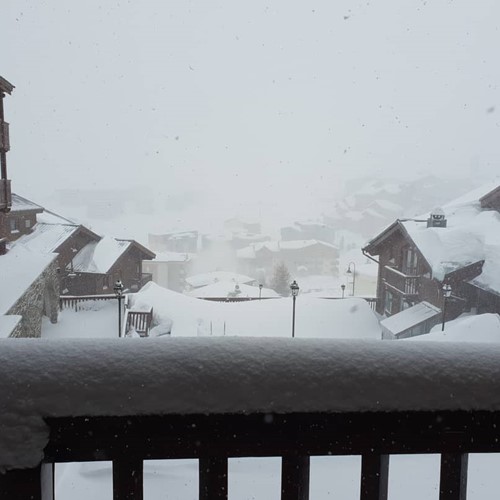 tignes le lac view of town from balcony in snow