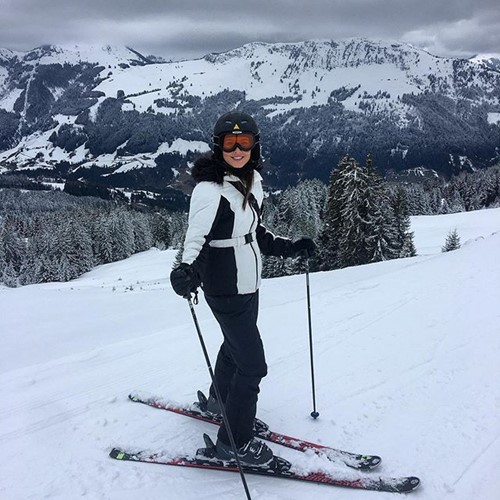 woman standing on skis in ski gear