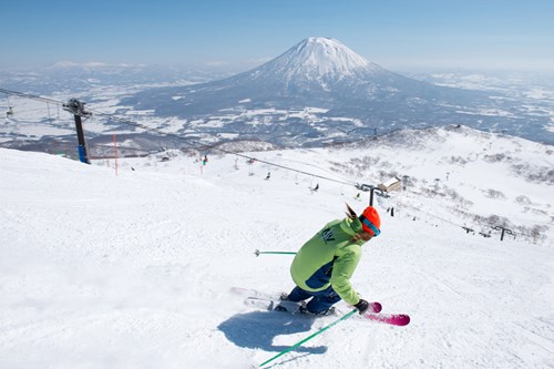Skiing in Niseko with a view of Mt Yotei, Skiing in Japan, blue skies