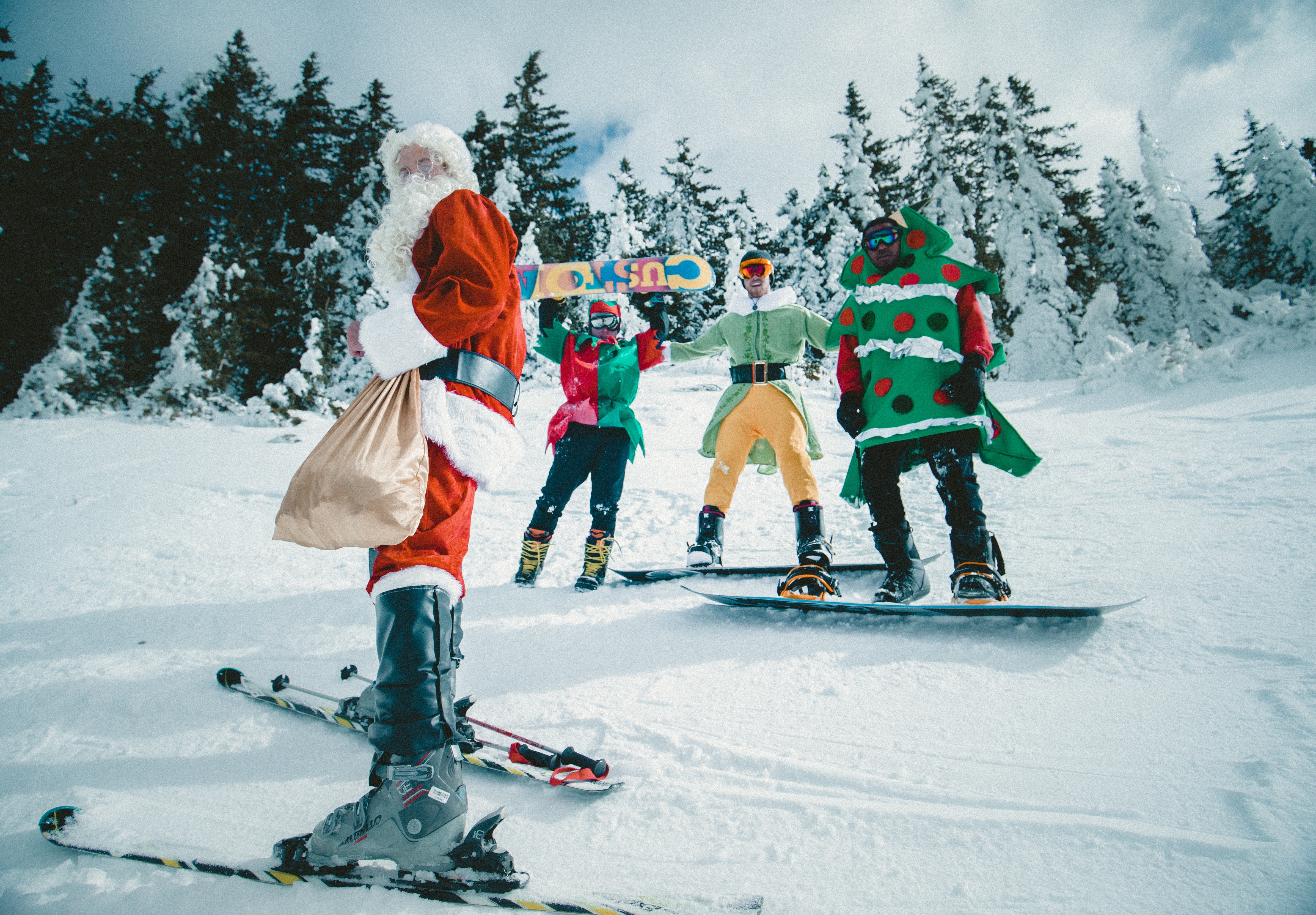 Skiing at Christmas, Santa and elves are skiing/snowboarding. Ski Christmas