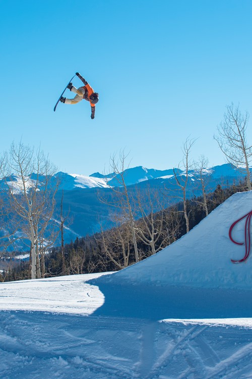 aspen sign snowboarder jumping