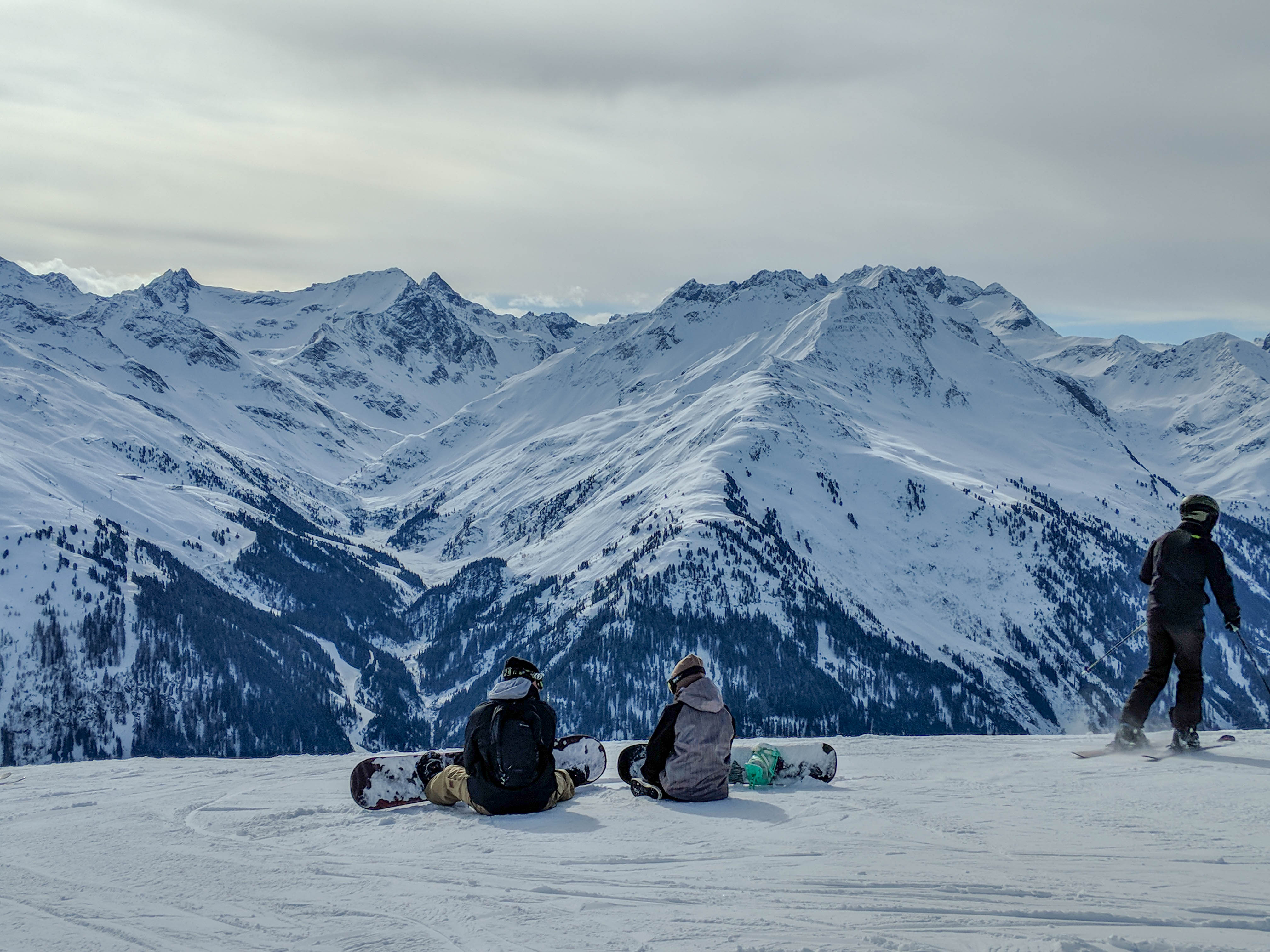 St Anton - Skiing - two boarders sat.jpg