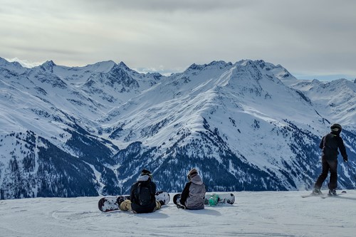 St Anton - Skiing - two boarders sat.jpg
