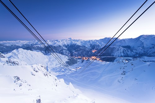 Courchevel ski weekends lift cables view of town sunset