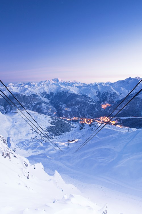 Courchevel ski weekends lift cables view of town sunset