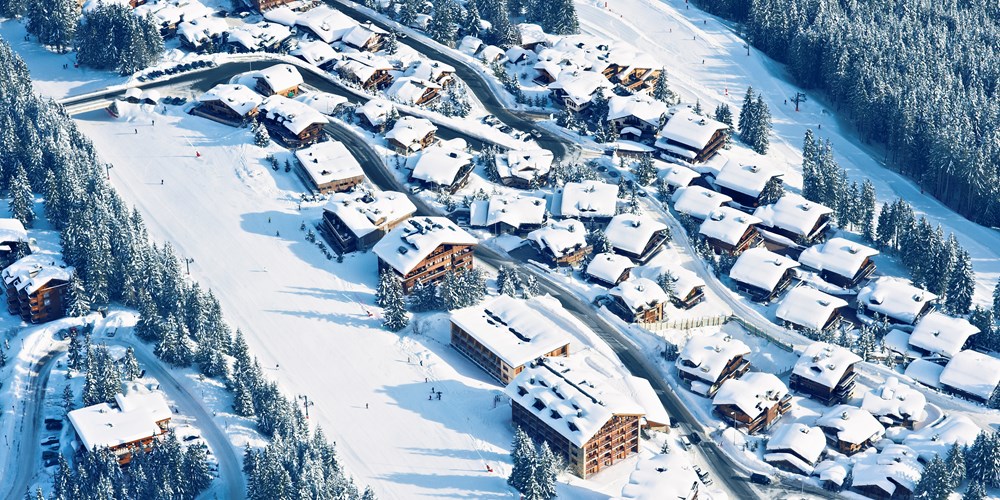 Courchevel ski weekends birds eye view of chalet buildings in snow